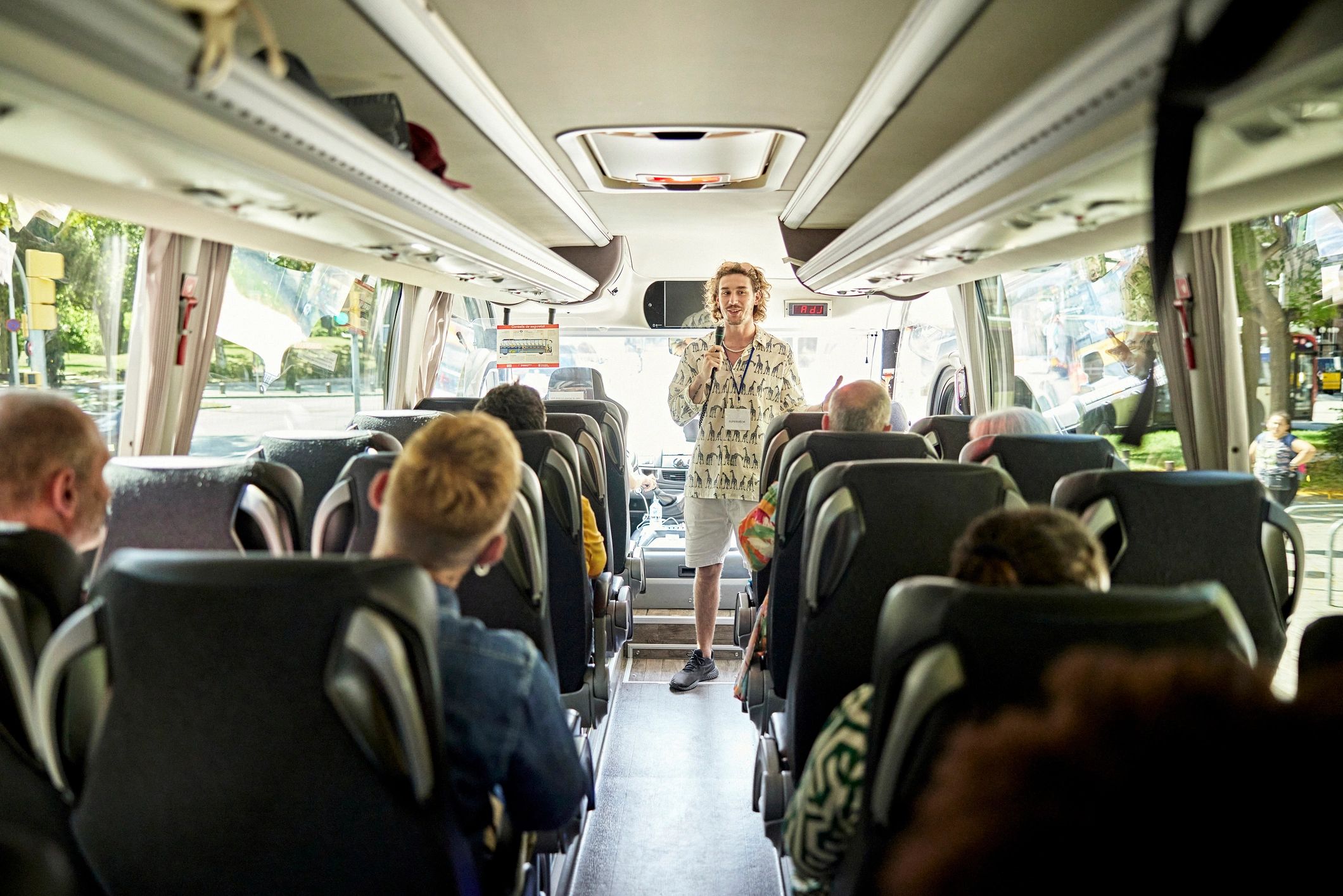 Coach tour guide speaking to travelers
